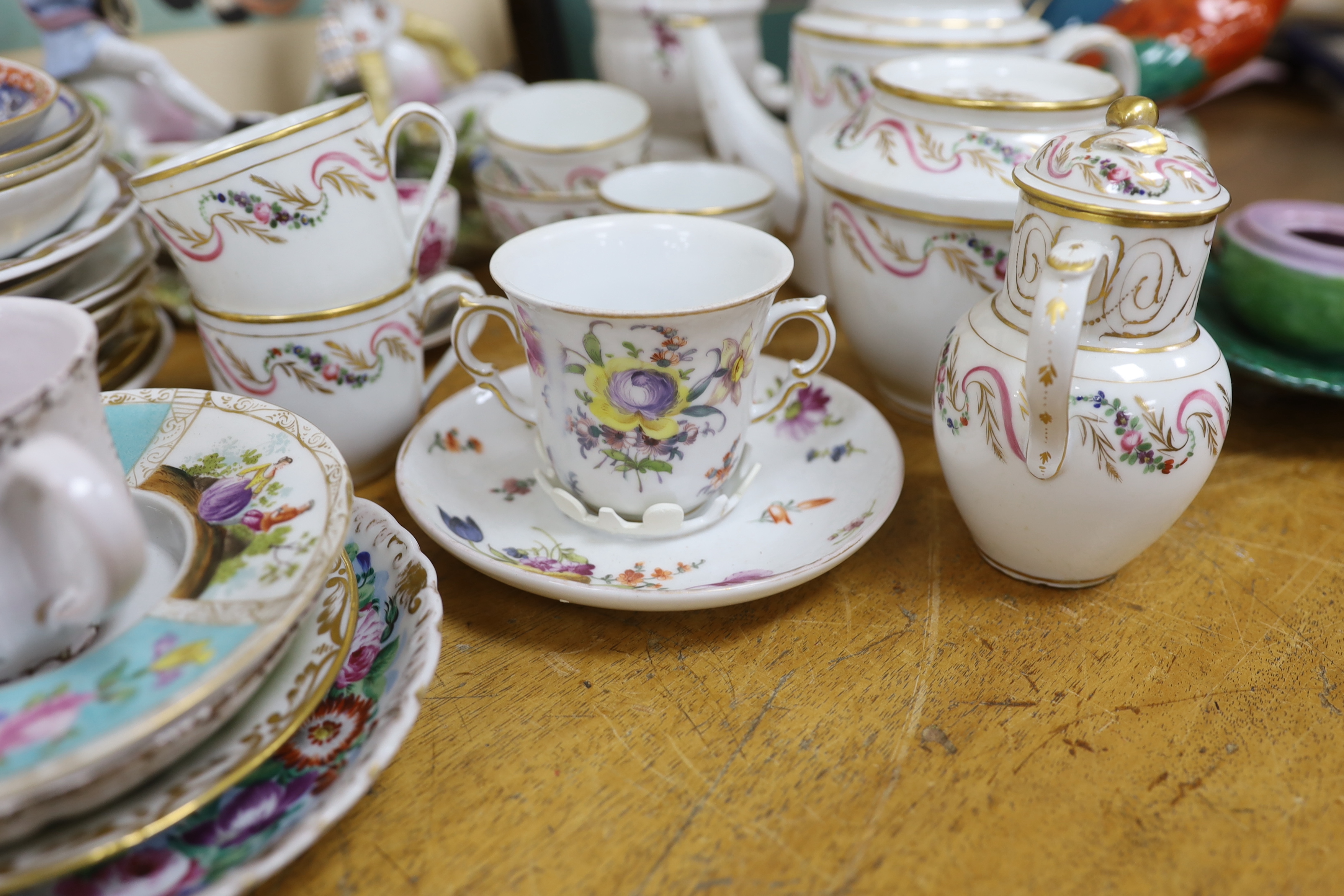 Assorted Continental ceramics, mainly 19th century, including two figures of parrots, two candle holders in the form of musicians, a teapot, jugs, various cups and sauces, etc.